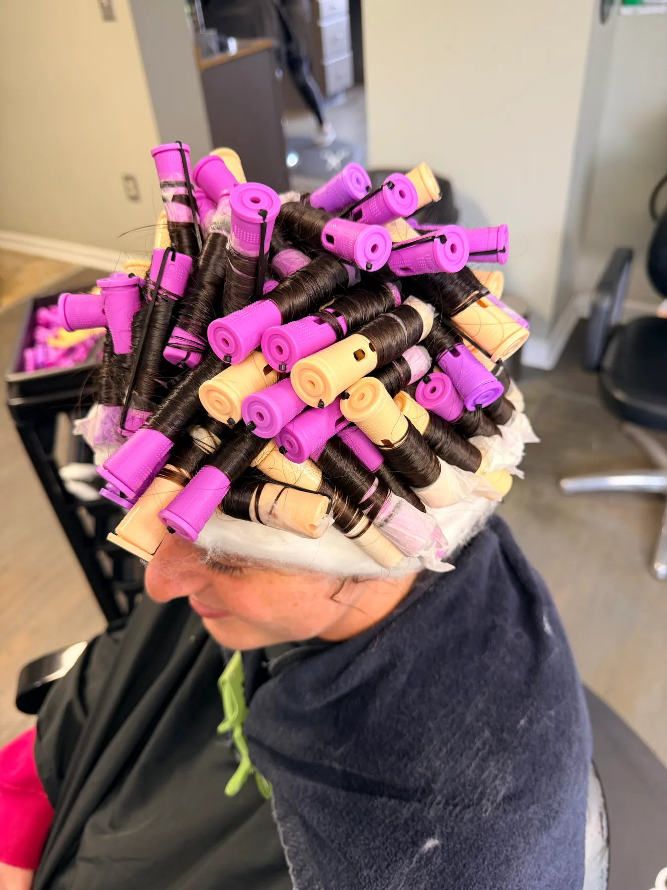 Hair wrapped in perm rods during a Hair Haven service