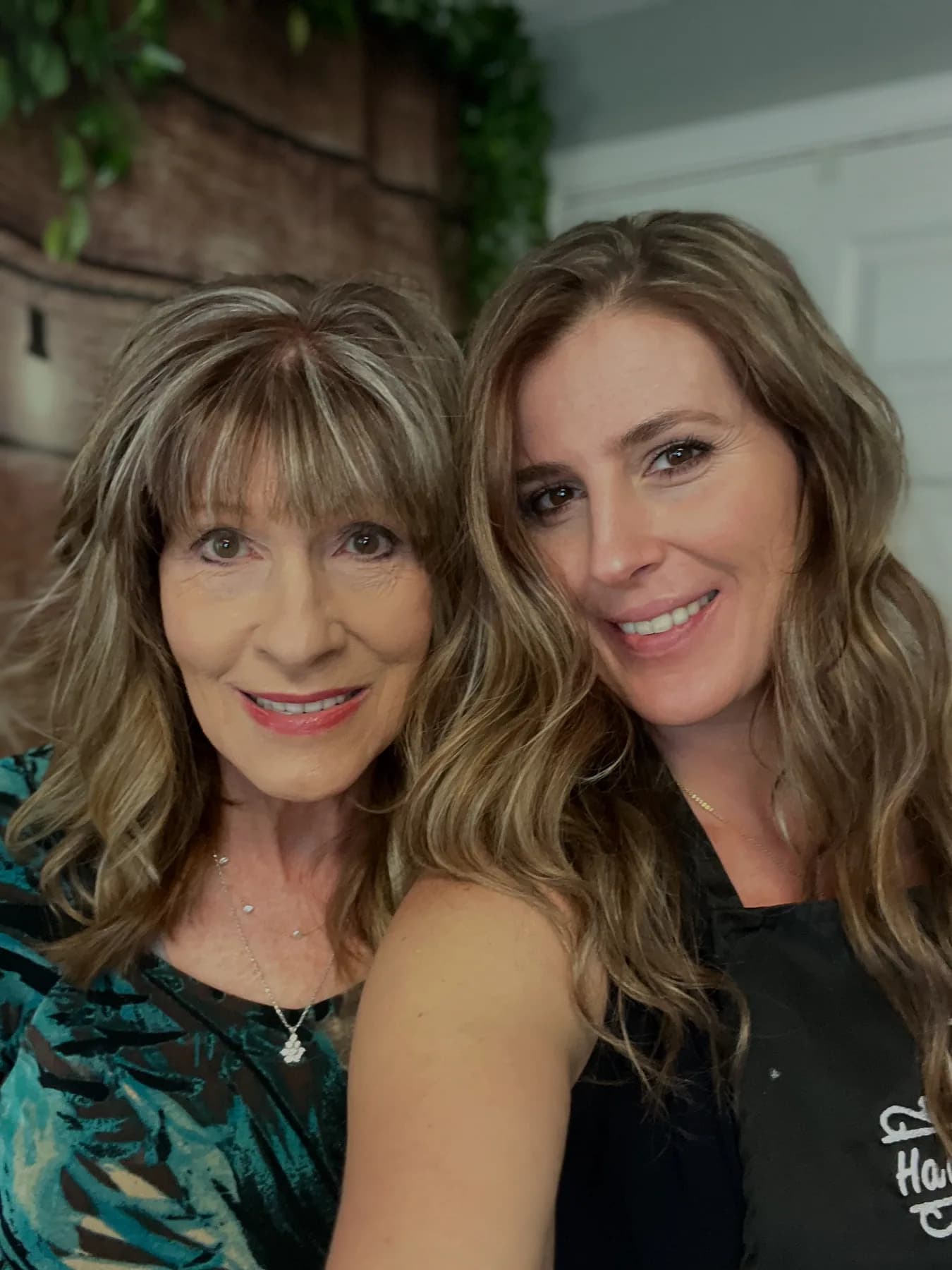 Mother and daughter showing their finished hair at Hair Haven