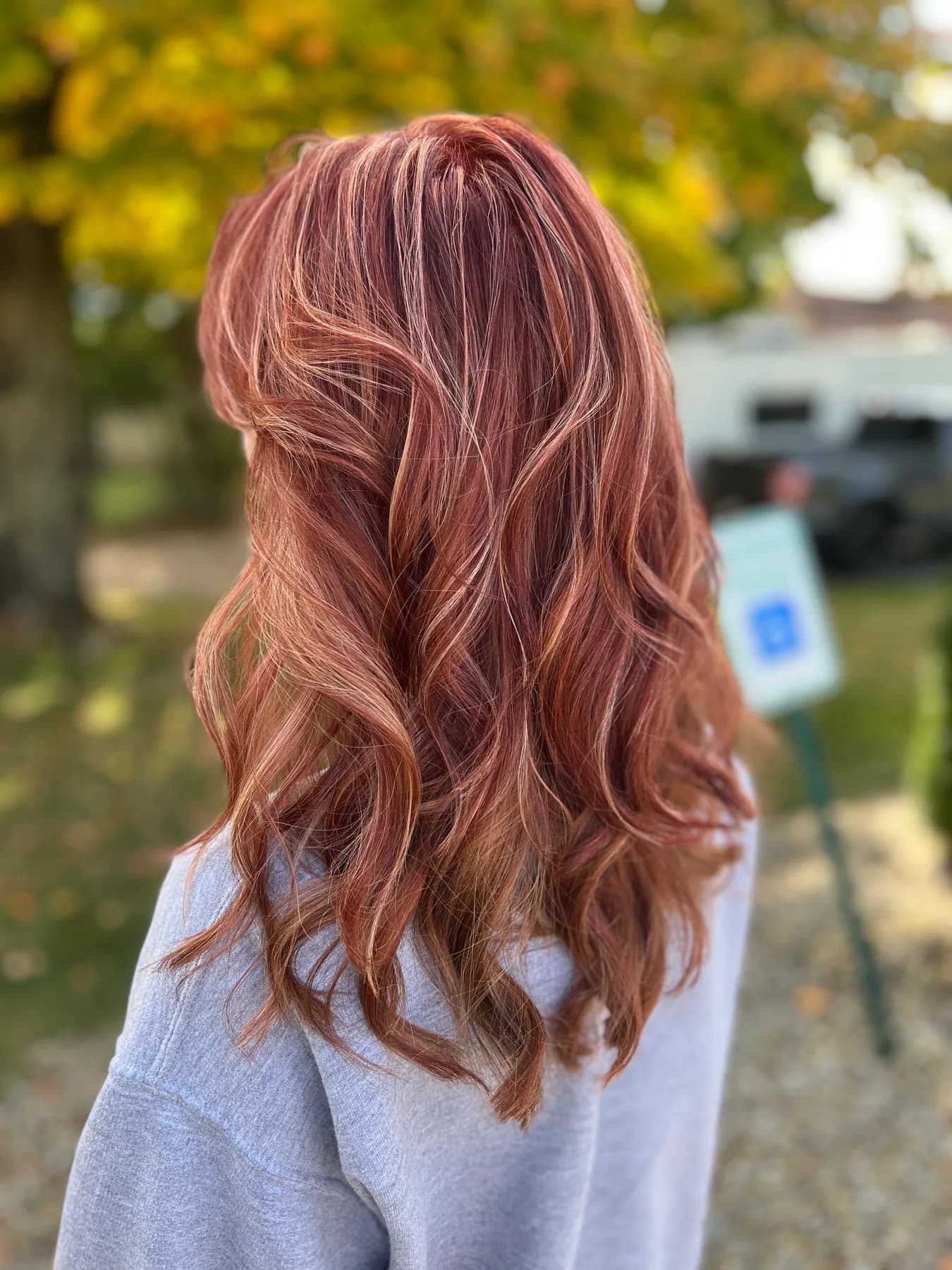 Long red hair with blonde highlights by Hair Haven